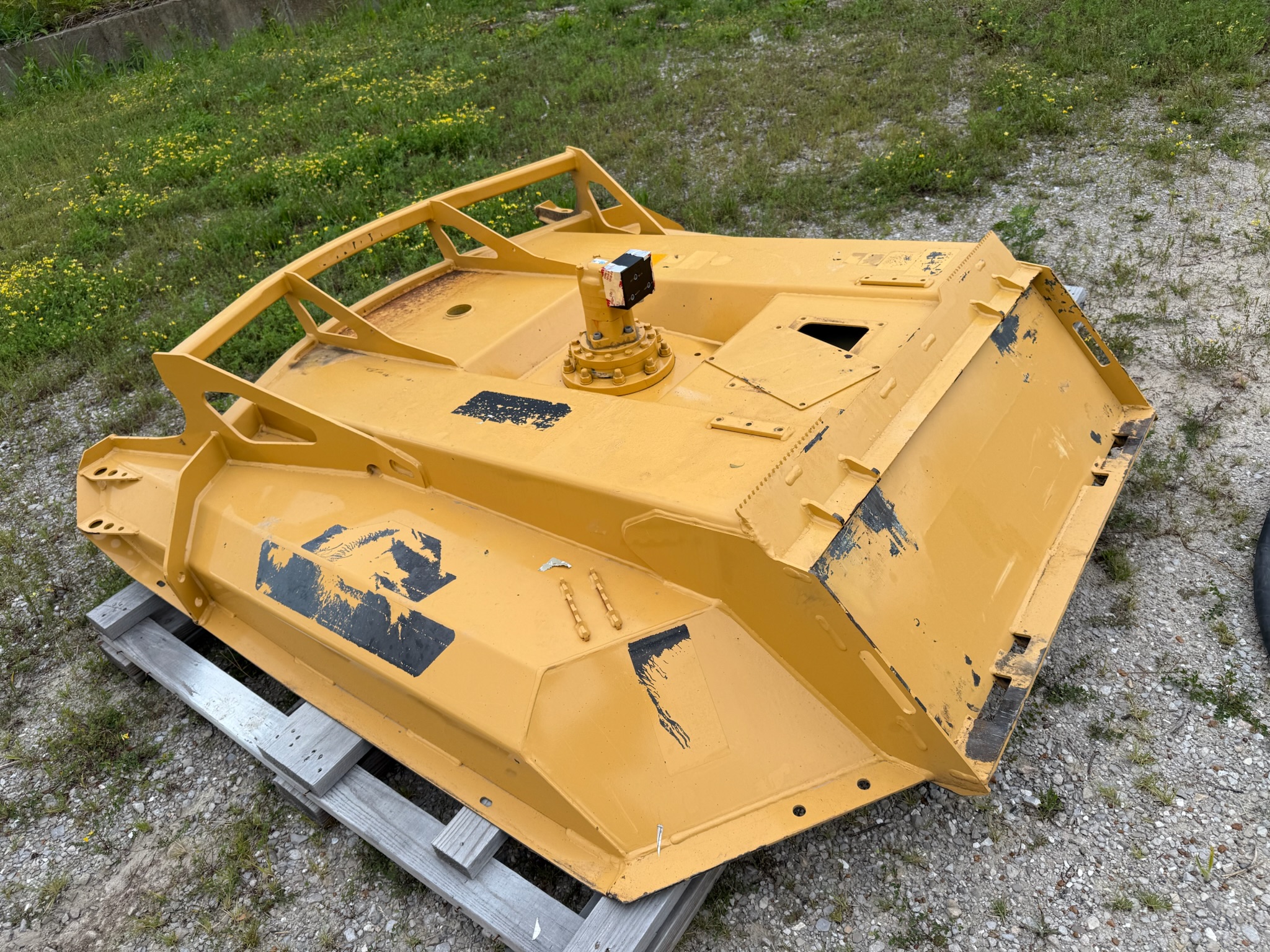 Heavy equipment cab panel with worn paint and rust before sandblasting